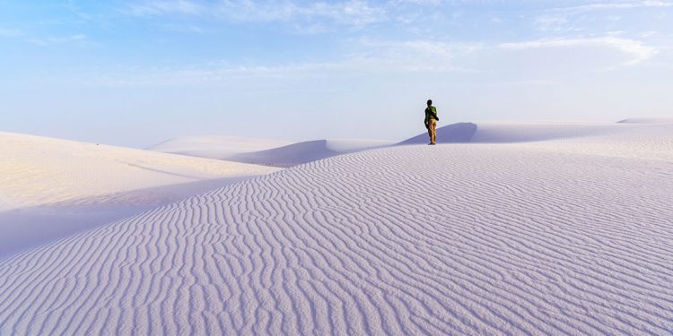 Person standing on white sands