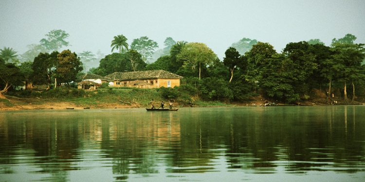 three fisherman rowing down a river in the Democratic Republic of Congo