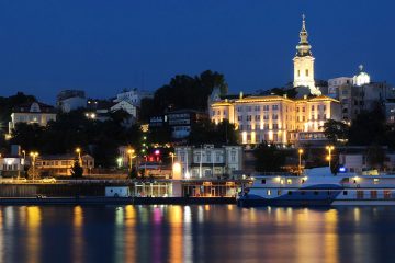 Belgrade cityscape at night with lights reflecting on the water