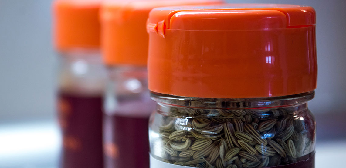 bottles of spices with orange lids