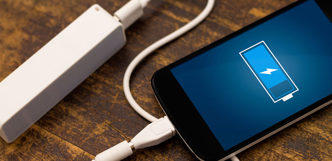 A battery backup charger for smartphones lay on the table.