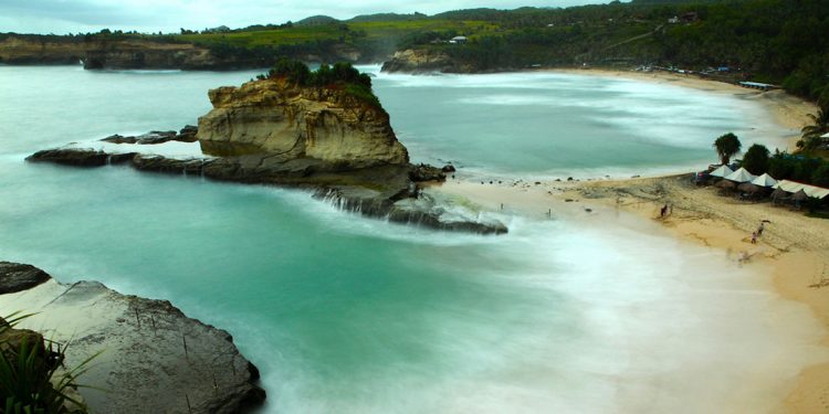 Low key beach of Pacitan has green waters with waves perfect for surfing.
