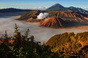 View from another mountain overlooking Mount Bromo at sunrise.