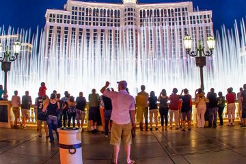 A crowd gathers in front of the water fountains at the Bellagio Conservatory in Las Vegas, Nevada