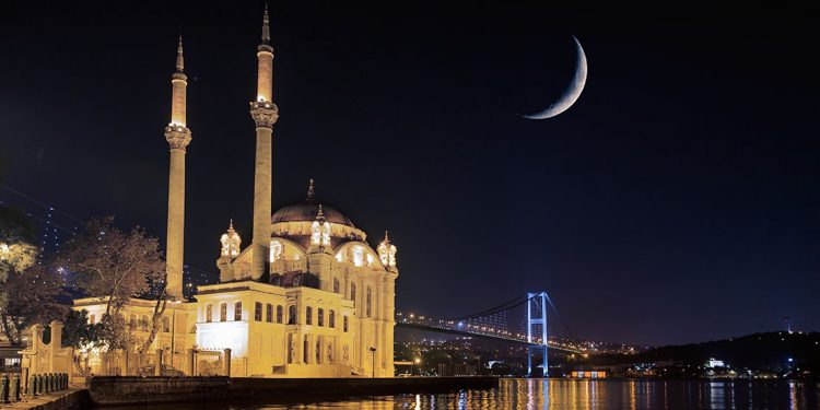 Crescent moon appears over a mosque in Istanbul, Turkey.