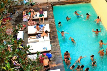 People enjoy the swimming pool at Plus Florence hostel