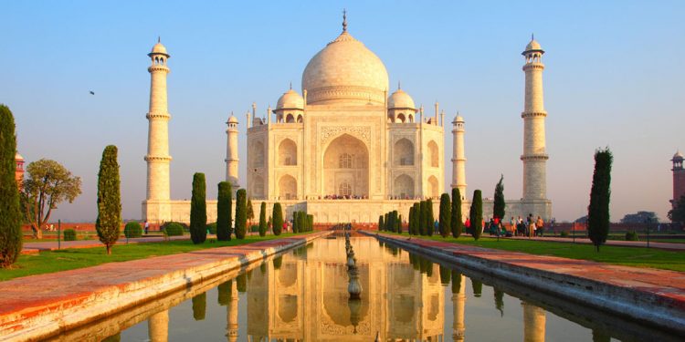 front of the taj mahal with garden