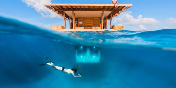 floating hotel room with diver underneath