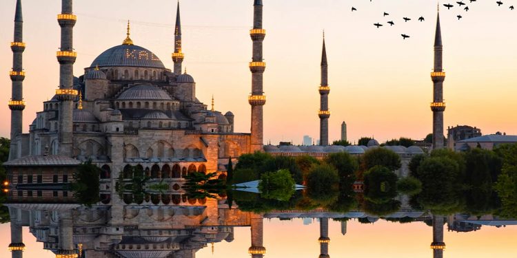 the sun sets on the Sultan Ahmed Mosque in Istanbul