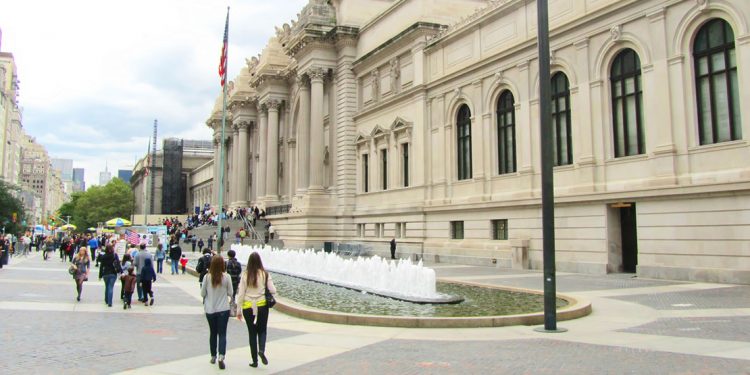 people walking in front of the Metropolitan Museum of Art in New York City