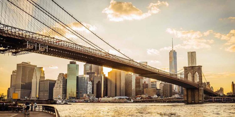 Brooklyn bridge and New York City skyline at sunset