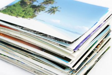 stack of postcards on a white surface