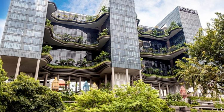 multi-story hotel surrounded by lush greenery