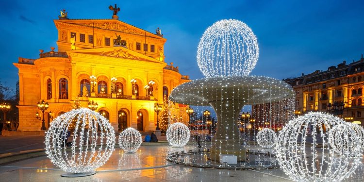 building with stunning architecture and fountain draped in christmas lights
