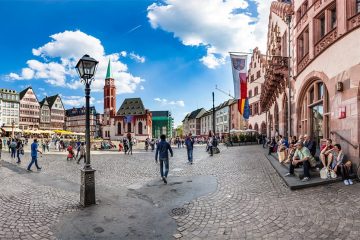 tourists walking through cobblestone city square