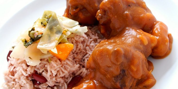 close up of sauced up oxtail and side of rice