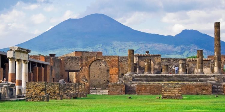 ruins of pompeii with mount vesuvius in the background