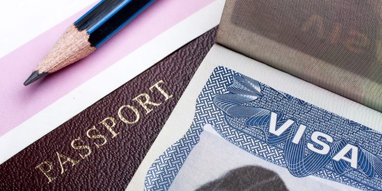 close up of passport and visa on a table