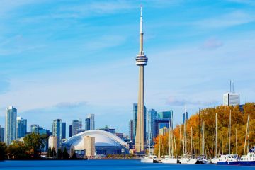 cn tower overlooks toronto harbourfront during fall