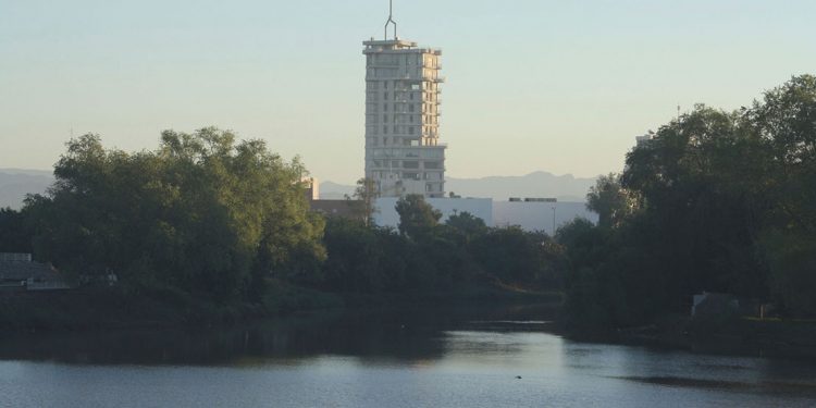 large building towering over water in culiacán, mexico