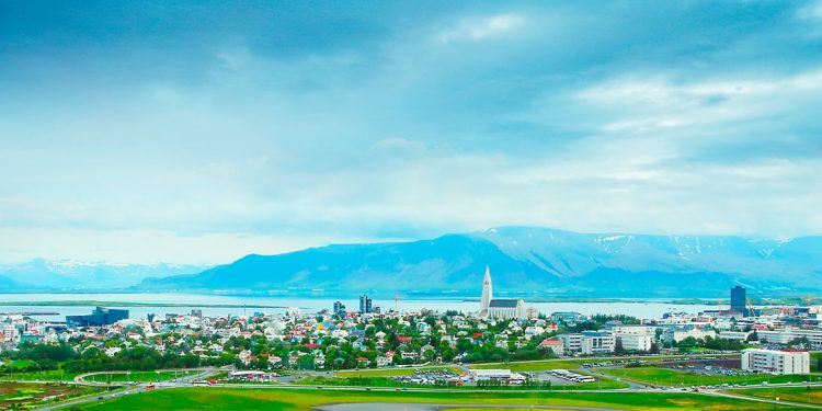 icelandic city with mountains in the background