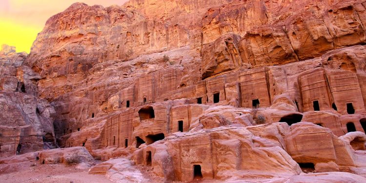 several ancient entryways built into the cliffs of ancient petra, jordan
