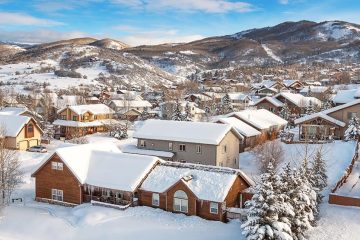 Snow covered houses and mountains beyond in Steamboat Springs, Colorado