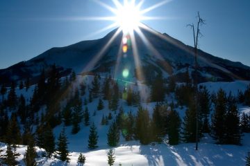 The sun sits atop a ski hill at Big Sky, Montana