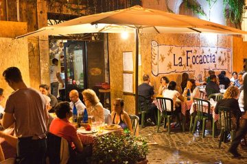 Outdoor seating at an Italian restaurant at night