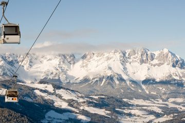 Chair lift with snowy mountains beyond in Kitzbühel, Austria