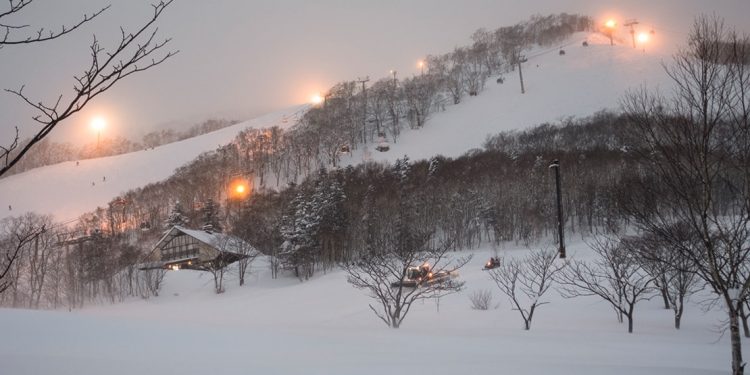 Ski hill lit up at night at Niseko, Japan