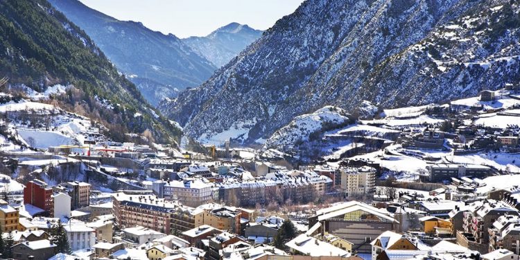 Snowy mountains lead down to an Andorran town
