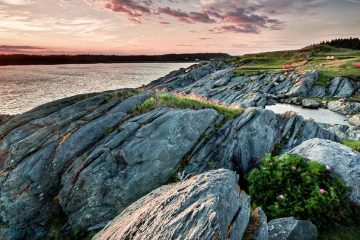 Sun rises over a rocky coastline in Canada