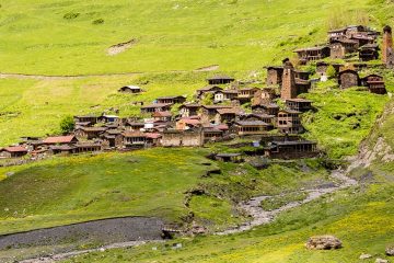 Georgian village in grassy mountains