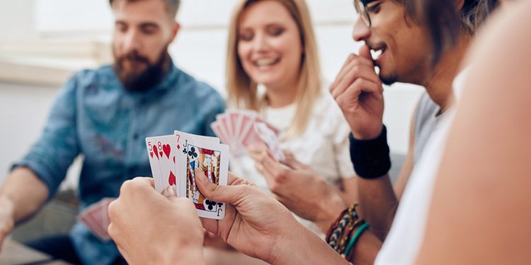 Group of four people playing a card game