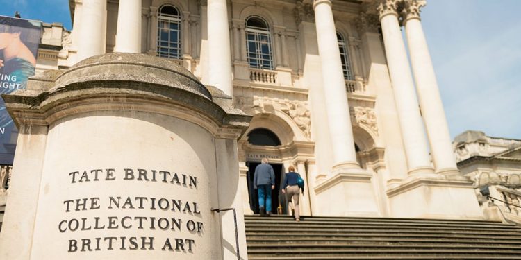 People walk up the front steps of Tate Britain
