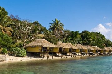 Dwellings with thatched roofs built on stilts over the water in Vanuatu