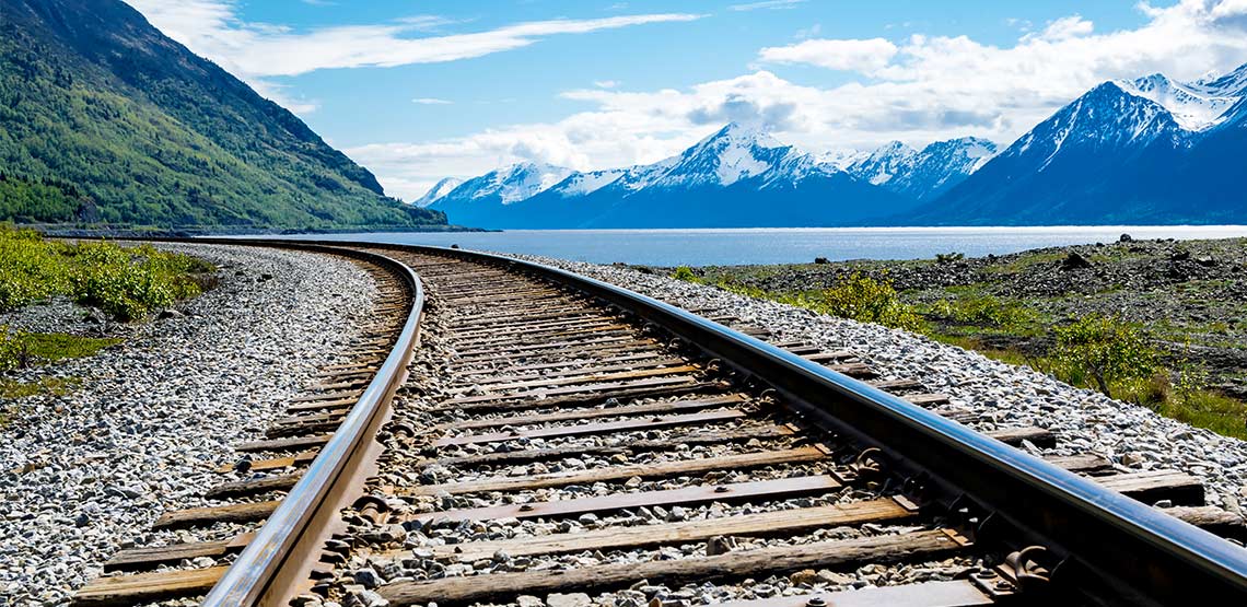 Train tracks with mountains in the background