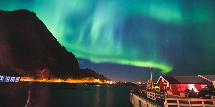 Beautiful green Northern Lights dance around Tromso, Norway's beautiful night landscape