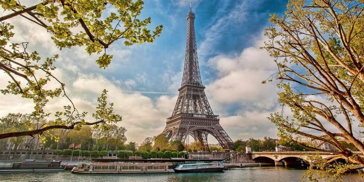 The Eiffel Tower stands tall while boat tours around Paris' canals continue going forward