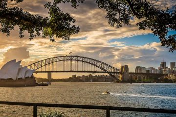 Sydney Harbour includes the famous Sydney's Opera House on the left and the city of Sydney on the right