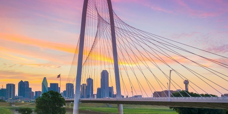 The Dallas bridge stands before the Texas city while the sun sets