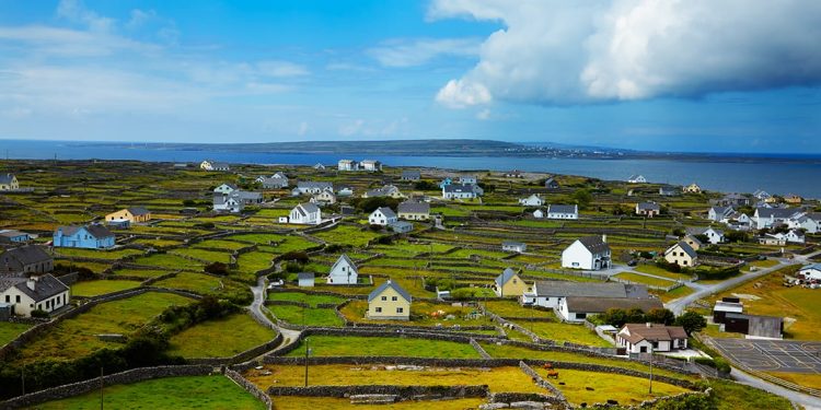 An Irish island with houses scattered across the island with farmlands