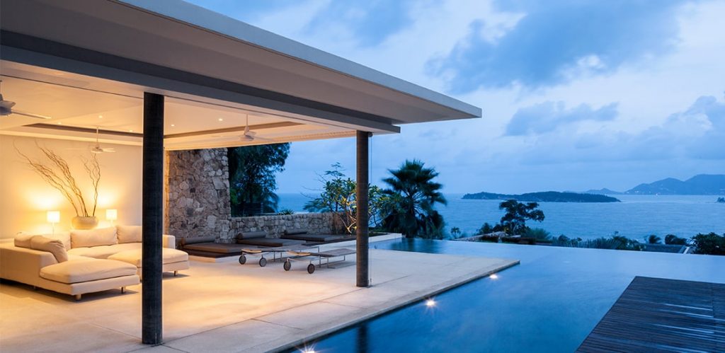 A luxurious hotel includes an outdoor sofa with a patio and private pool with a view of the ocean