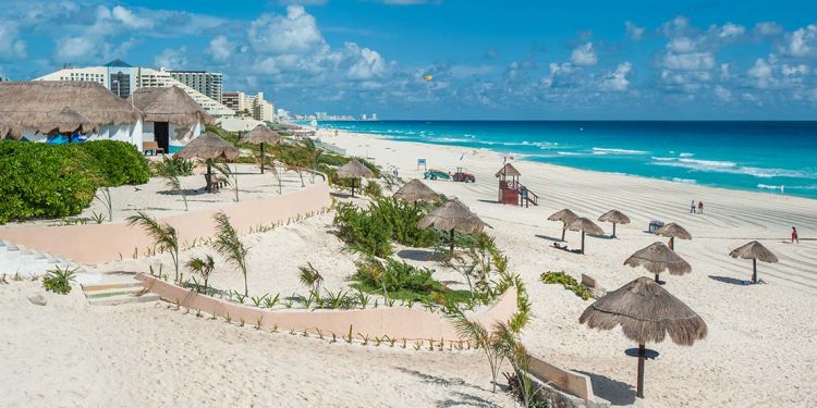 A resort in Mexico contains miles of white sand beaches and beautiful turquoise ocean waters