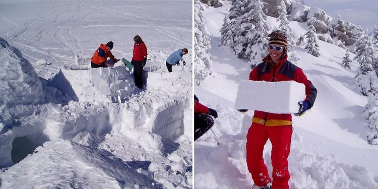 A family working together to build an igloo with snow bricks