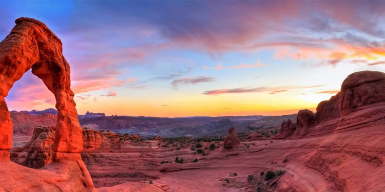 The sun sets on the rock formation of the Arches National Park in Utah
