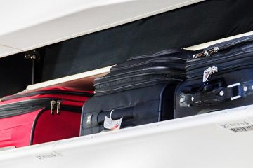Carry on luggage in the overhead bin of an aircraft