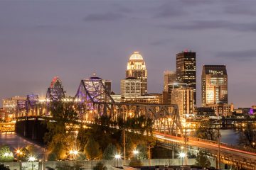 The city of Louisville, Kentucky lights up before night begins