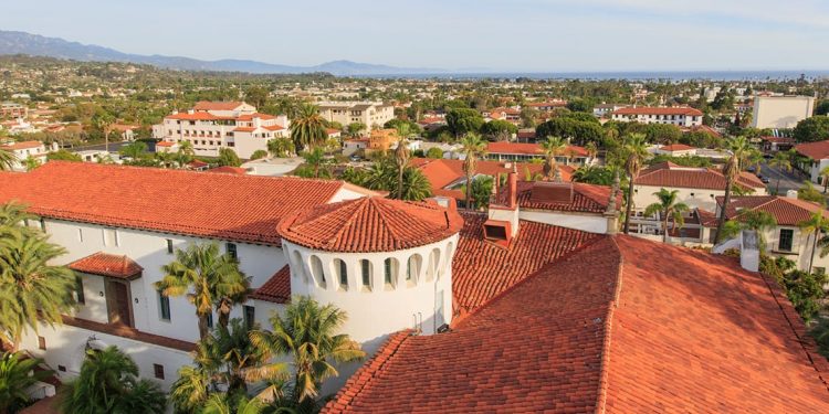 Houses with white siding and red roof shingles cover the city of Santa Barbara, California